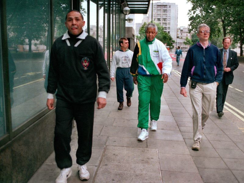 South African President Nelson Mandela takes a 6 am walking along Park Lane, accompanied by his bodyguards, during a visit to London, July 1996. He is wearing a track suit in the South African national colours, with the Olympic logo on them. (Photo by Tom Stoddart/Getty Images)